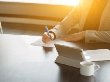 woman signing document