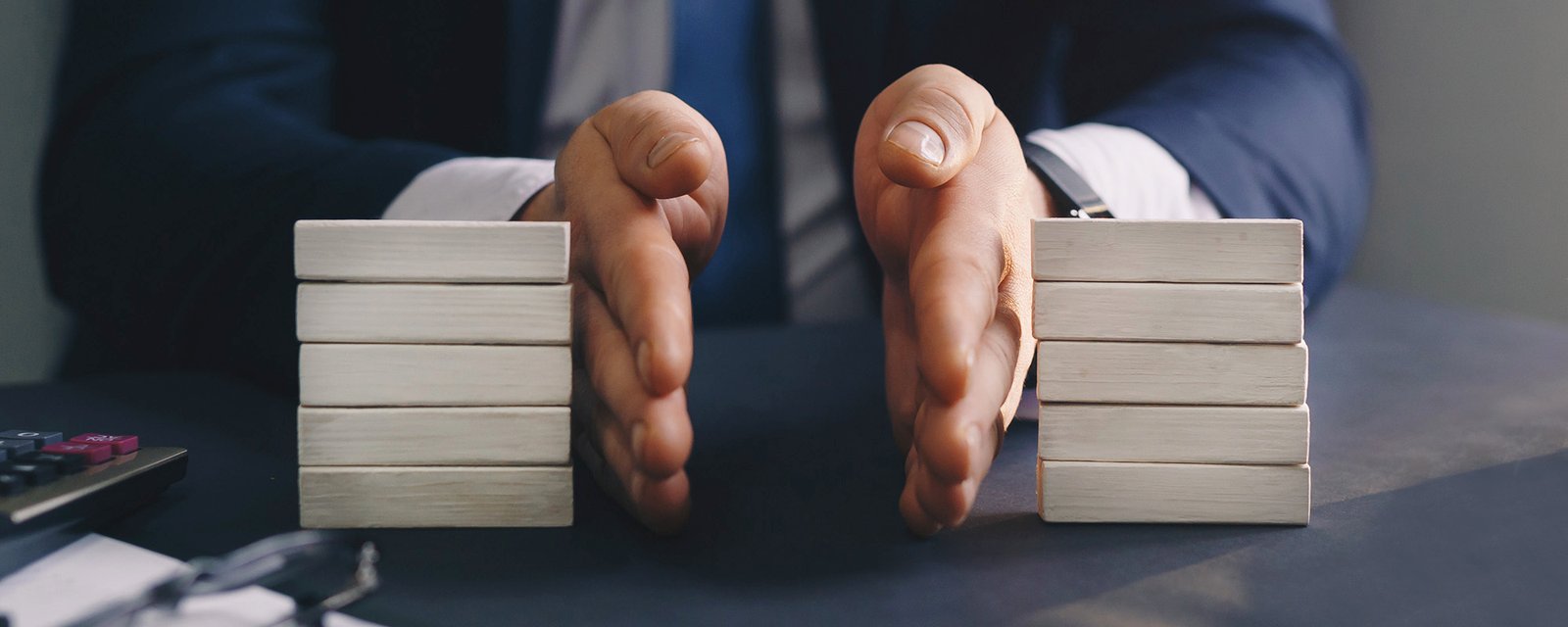 Businessman separates wooden block. Property division. Divorce and legal services. 